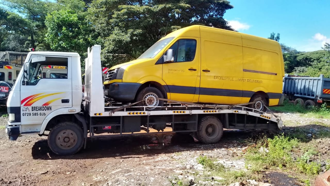 Commercial delivery van loaded onto a towing truck