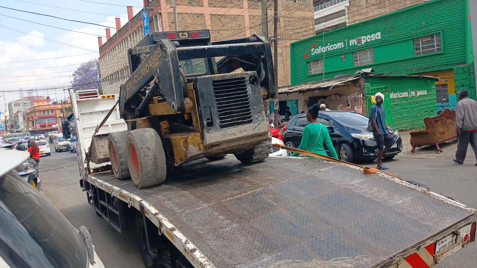 Earth moving machinery being loaded onto a recovery truck