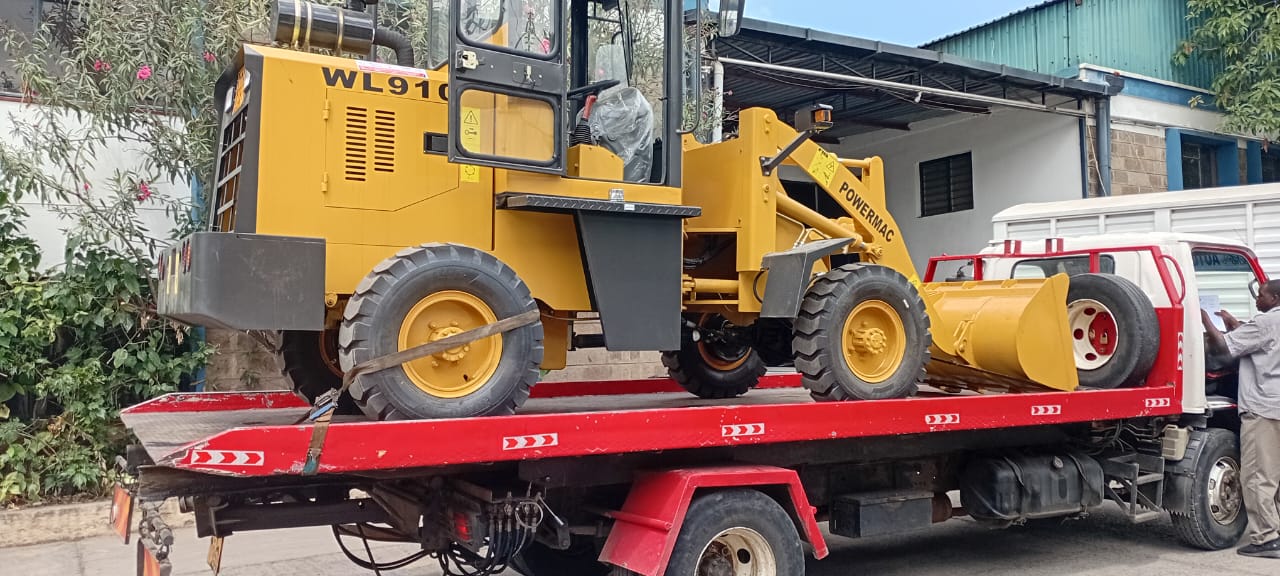 Wheel loader secured on a flatbed for heavy equipment towing